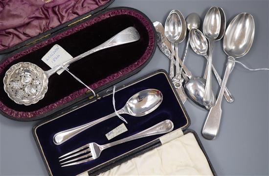 An Edwardian silver Christening set, a Victorian silver sifter spoon and a quantity of miscellaneous silver flatware.
